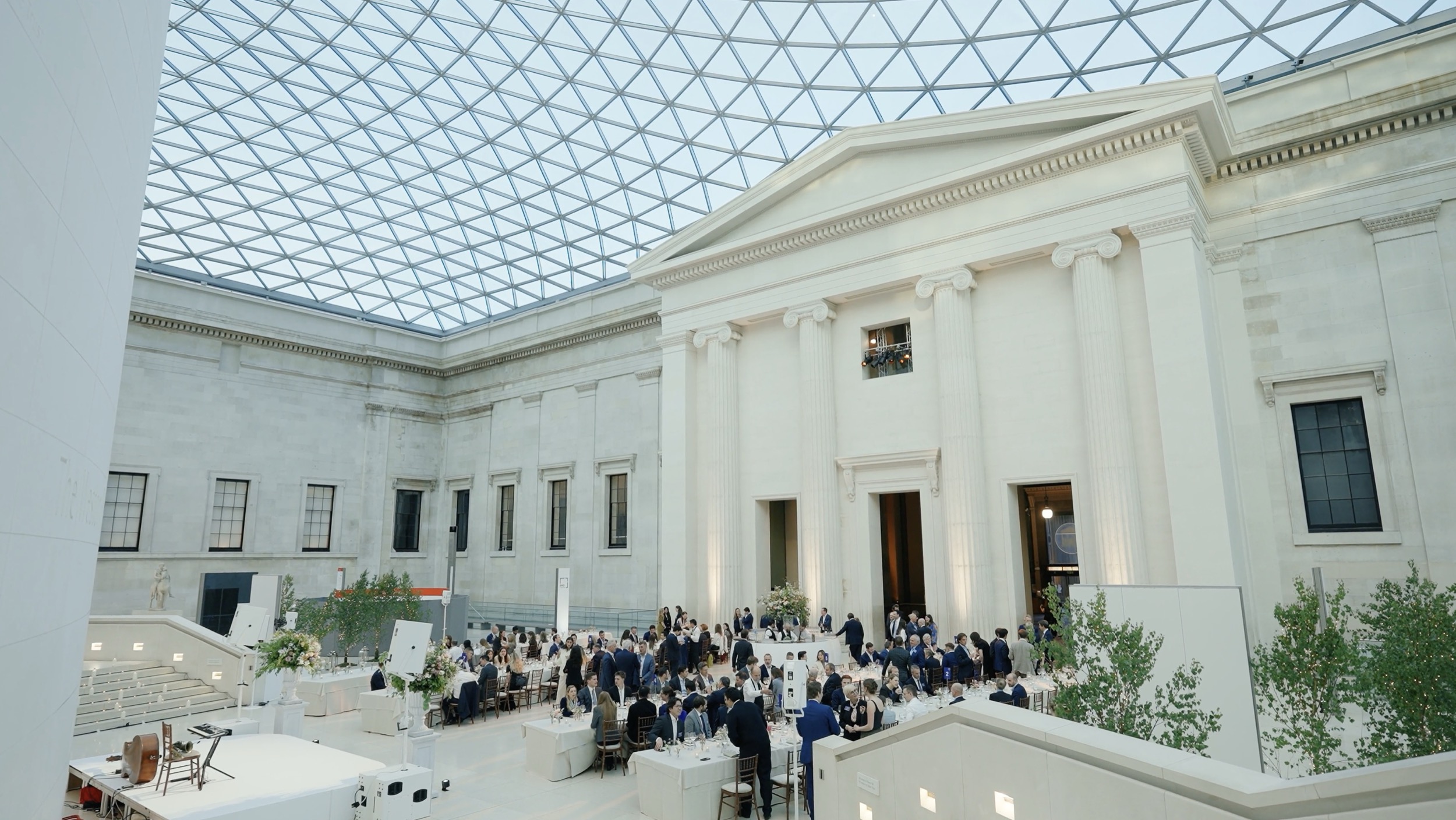 Premium gala dinner setup with elegant styling in the Great Court under the glass roof at the British Museum