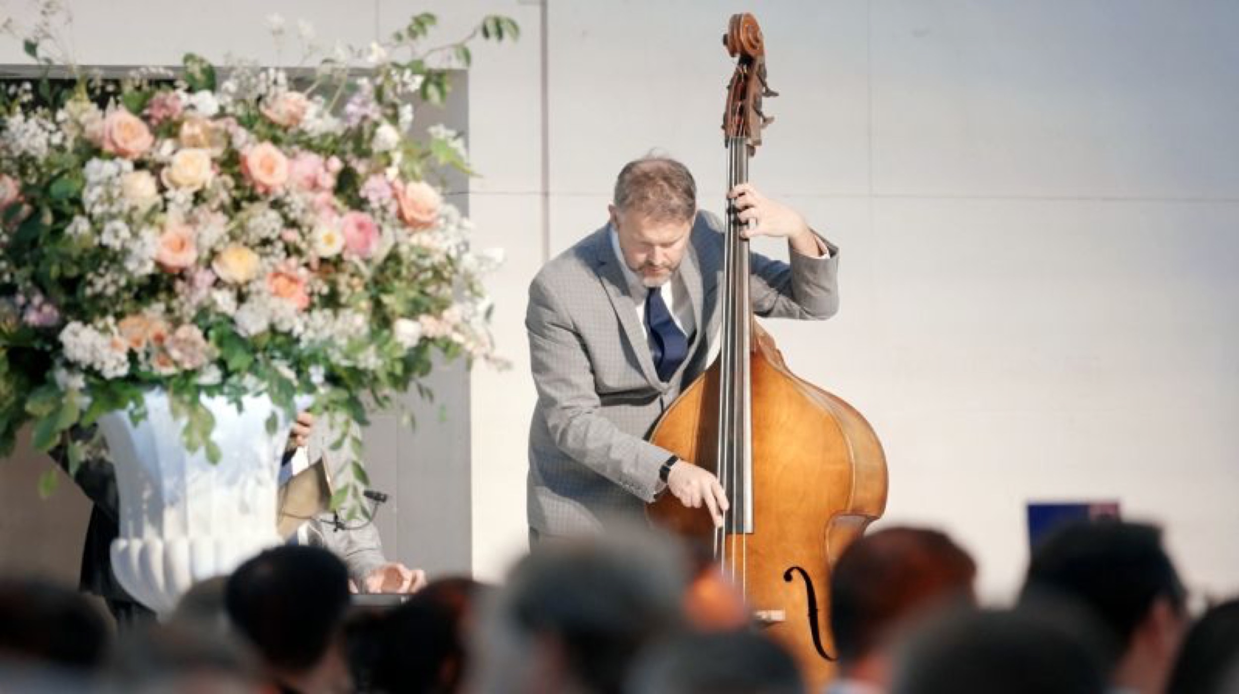 High-end corporate networking event with audience watching live cello inside a the Great Court