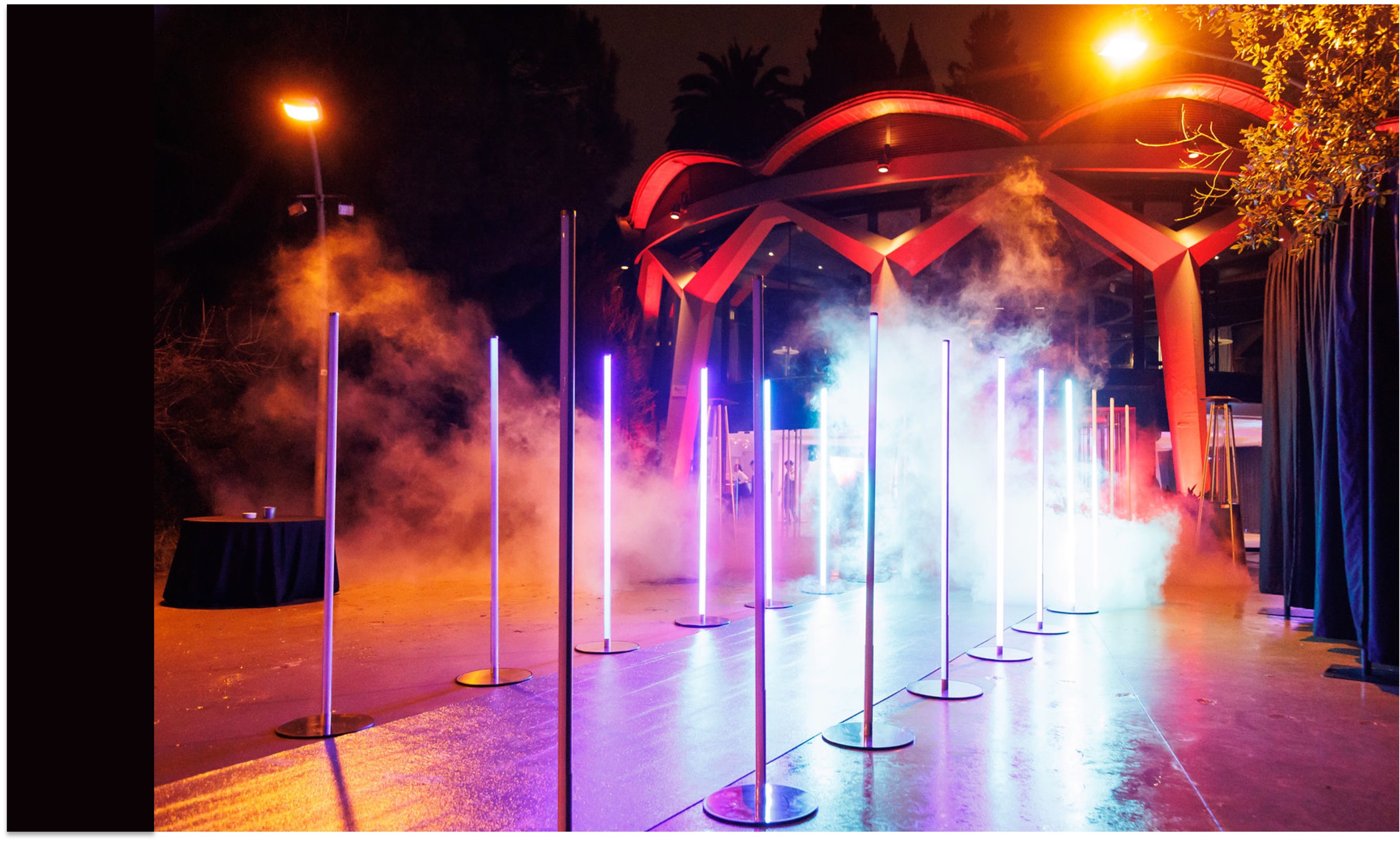 Blue-lit exterior of Esferic venue in Barcelona with a black carpet entrance and motion-sensor lighting for a VIP gaming event