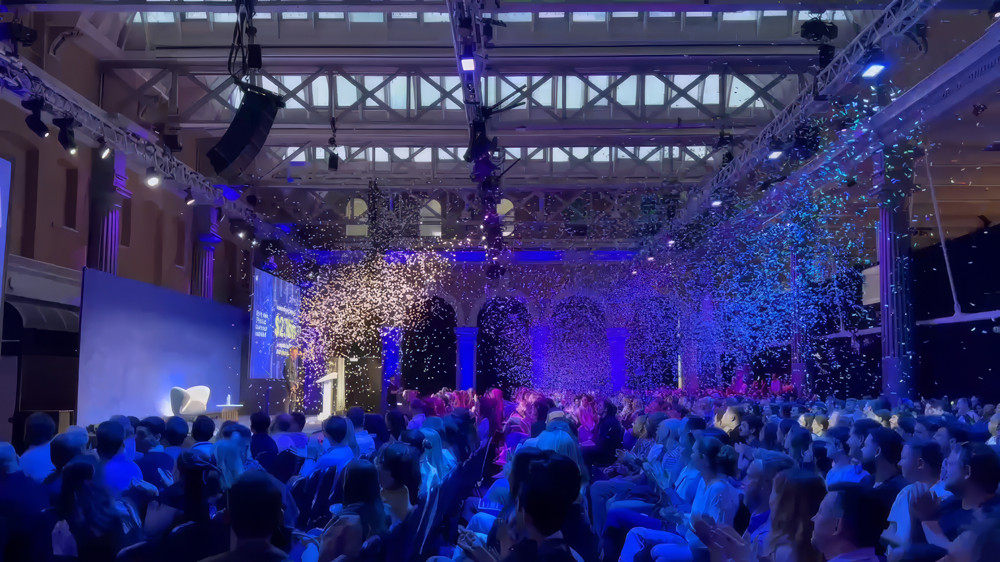 Confetti cannons blasting on stage at the end of a corporate conference session in central London venue