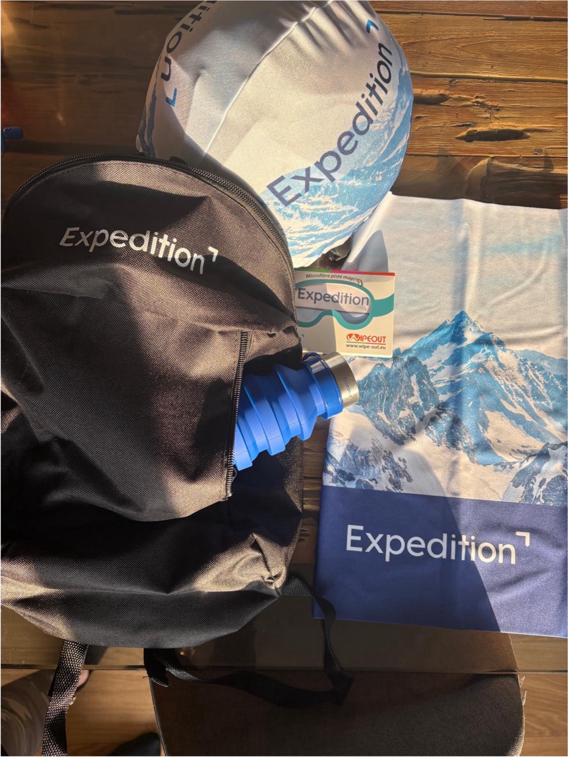 Bespoke branded gift pack including custom water bottles and ski accessories awaiting corporate guests in hotel room